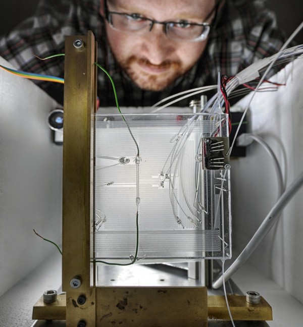 Photo gallery - category: Research - Dr Sławomir Jakieła measures the speed of microdroplets in a microfluidic system.